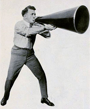 Man holding and talking into megaphone