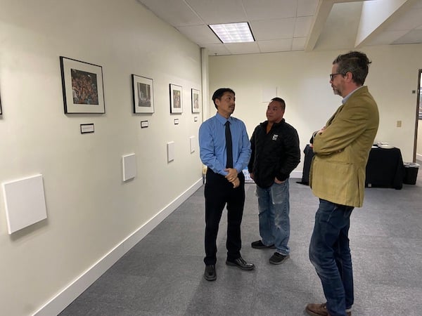 Todd Mahon talks with Shia Yang in the Hmong Museum Gallery