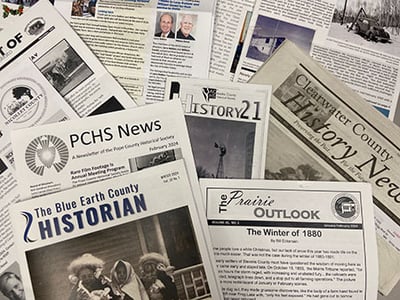 Local history newsletters in a pile
