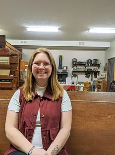 Photo of Demery Maughan in her native environment at the Fillmore County Historical Society Museum