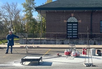 Mad scientist with equipment in front of library or maybe someone leading Library Emergency Response Training