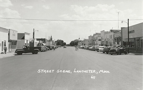 1950s Street scene looking down center of street, Lancaster, Minnesota