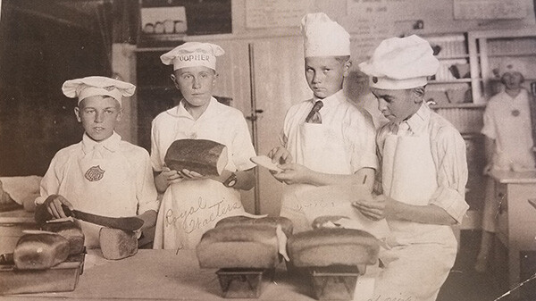 1920 State Fair bread bake-Four boys in bakers uniforms with bread