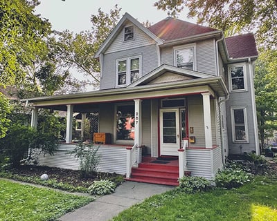 Exterior of a 1900s victorian house with a front porch