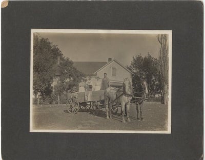 Couples in a wagon, c.1900