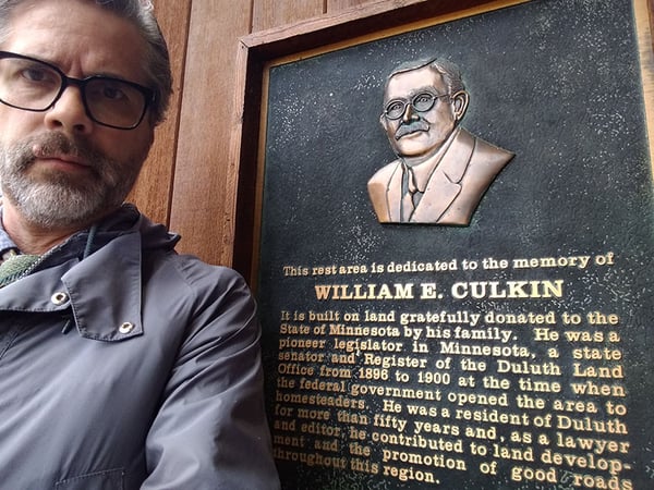 Todd Mahon next to plaque of William E. Culkin