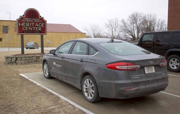 Nobles County Hertiage Center signage and a very dirty MN State vehicle