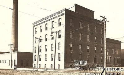 Hubbard Mill circa 1900, black and white image with a building and a cart