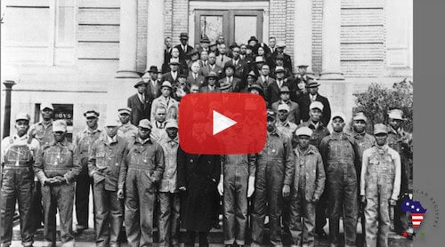 Video screen shot showing group of African American men in front of building-ca. 1930s