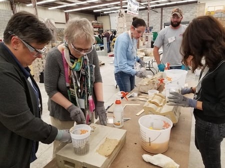 Instructor and several students at a masonary workshop