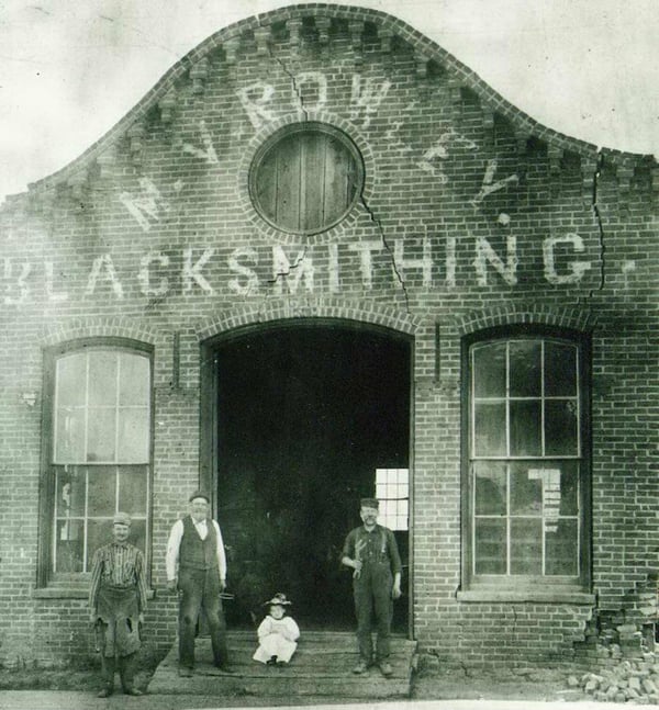 M. V. Rowley Blacksmithing located at 22 North Broadway. This shop opened in 1873. Photo 1896