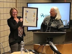 ACHS Director Rebecca Ebnet-Desens holding award