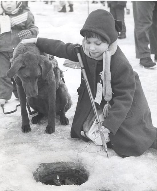 LHN-Little girl with her dog at ice fishing contest in 1956