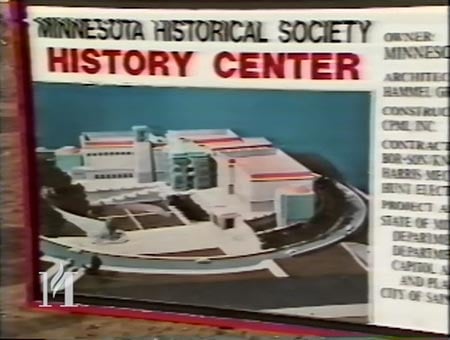 Screen capture of VHS video construction celebration showing a model of the Minnesota History Center