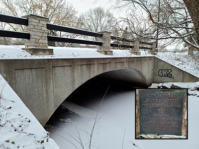 Bridge spanning creek, The photo has inset image showing the bridges aluminium information plaque_