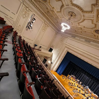 Interior of the Goodman Auditorium showing stage, plasterwork, and chandelier