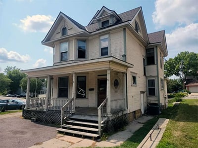 Photo showing front and side of house that was purchased