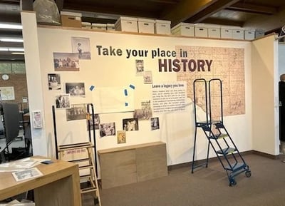 Exhibit wall construction - Title on wall says, Take Your Place in History 
