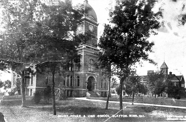 Historic photo of the first Murray County Courthouse with high school in background