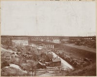 Sepia photograph of Swede Hollow with the Sixth Street Bridge in the background, ca. 1900