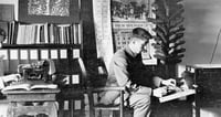 Black and white photograph of Alfred Carlsted counting sprouted kernels to determine the percent that germinated, 1914.