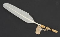Feather for cleaning miniature tea set