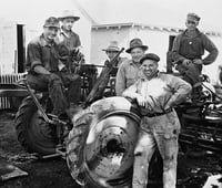 Black and white photograph of German prisoners of war operating farm equipment in Moorhead, ca. 1943–1945. Used with the permission of the Historical and Cultural Society of Clay County.