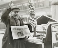 Black and white photograph of a man selling a newspaper with headline related to Bremer kidnapping, 1935.