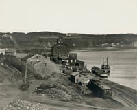 Black and white photograph of James J. Hill warehouse on St. Paul's Mississippi River levee, c.1869.