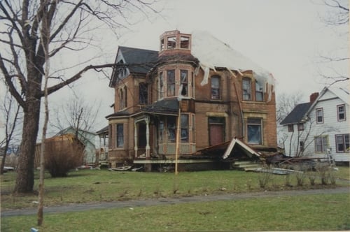 Photograph of badly damaged house.