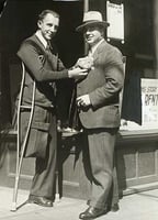 Black and white photograph of Congressman Melvin Maas (right) with a disabled constituent, 1930.