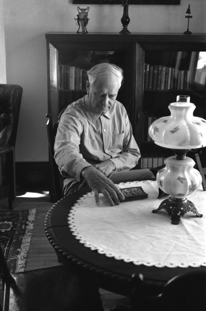 Black and white photograph of Charles Lindbergh in the living room of his restored boyhood home, 1971.