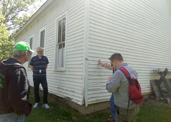 Staff surveying damage to historic school house