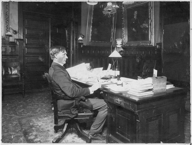 Governor John Lind seated in his office in the State Capitol