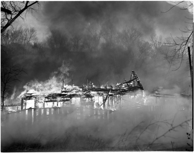 Black and white photograph of the burning of Swede Hollow, St. Paul, 1956