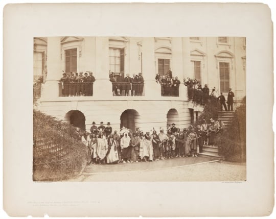 Native delegation in Washington, D.C. Bagone-giizhig is standing on the balcony, to right of second pillar from the left