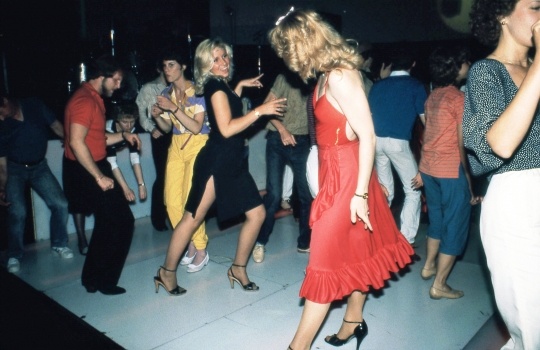 Color image of Disco dancers at Uncle Sam’s, ca. 1977. Photograph by Steven Laboe.