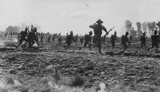 Black and white photograph of officer candidates advancing during military maneuvers, 1917.
