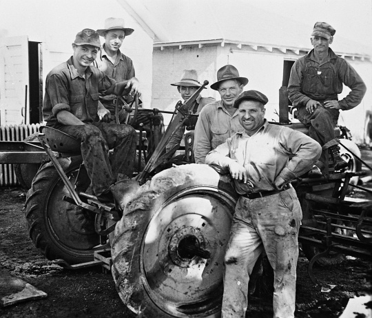 Black and white photograph of German prisoners of war operating farm equipment in Moorhead, ca. 1943–1945. Used with the permission of the Historical and Cultural Society of Clay County.