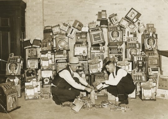Black and white photograph of a police raid on slot machines, St. Paul, 1935. Photograph from the St. Paul Daily News.