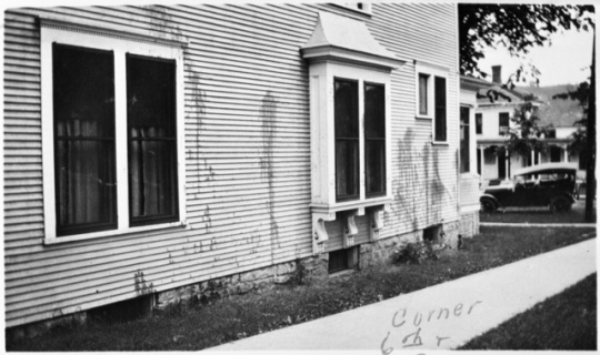 Black and white photograph of Frederick A. Scherf's home splattered with paint.