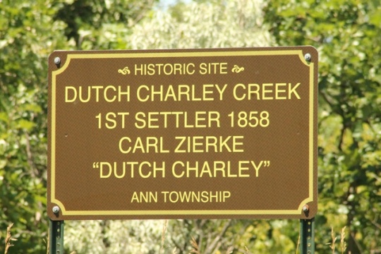 Color image of a commemorative sign erected in 1949 to mark the site of the Zierke family cabin, ca. 2010. Photograph by Dave Van Loh.