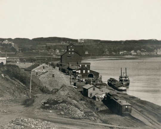 Black and white photograph of James J. Hill warehouse on St. Paul's Mississippi River levee, c.1869.