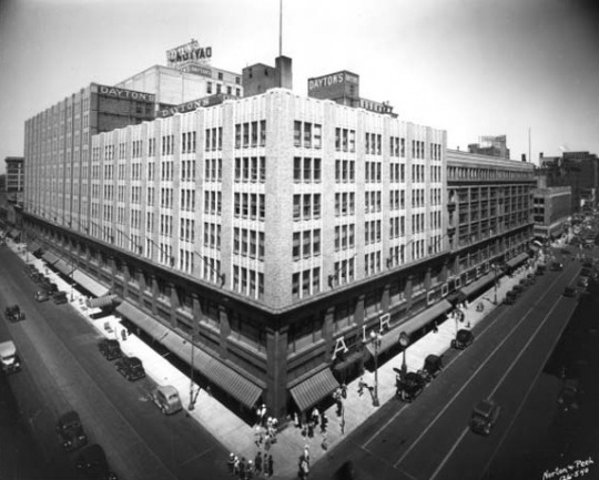 Black and white photograph of the expanded downtown store complex, c.1938. The original store is in the darker shade.