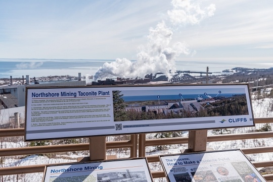 Northshore Mining, formerly Reserve Mining, is located in both Babbitt and Silver Bay. The processing plant is located in Silver Bay. In this picture, the plant is visible along with a placard describing the taconite beneficiation process. Photo by Tony Webster, March 10, 2018. CC BY-SA 2.0.