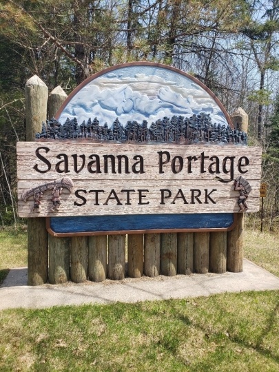 Entrance sign at Savanna Portage State Park acknowledging the area’s Indigenous and fur-trading history, 2018. Photograph by Jon Lurie used with the permission of Jon Lurie.