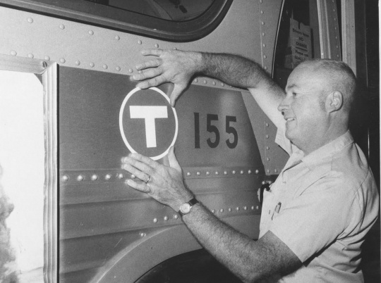 A transit worker applies a “T” (for transit) decal to one of the old Twin City Lines buses before being sent out on the streets under new management for the first time in September 1970. All of the former TCL buses were eventually repainted a solid red before until they were replaced. Photo by the St. Paul Pioneer Press used with permission.