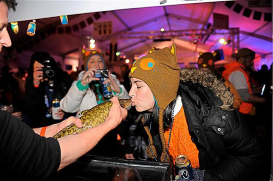 Kissing an eelpout for luck at the International Eelpout Festival, Walker, 2013. Photo by Josh Stokes.