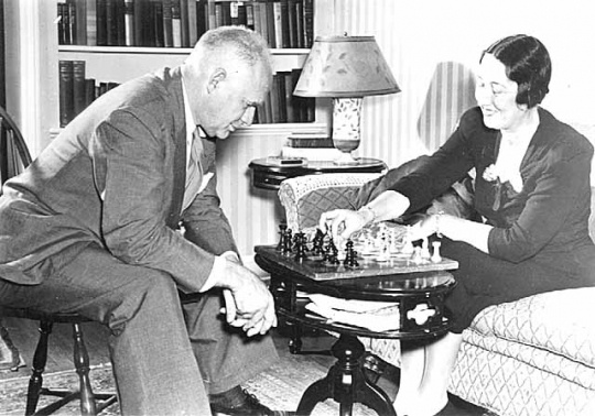 Black and white photograph of Maud Hart Lovelace and husband Delos playing chess, c.1945.