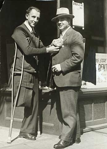 Black and white photograph of Congressman Melvin Maas (right) with a disabled constituent, 1930.